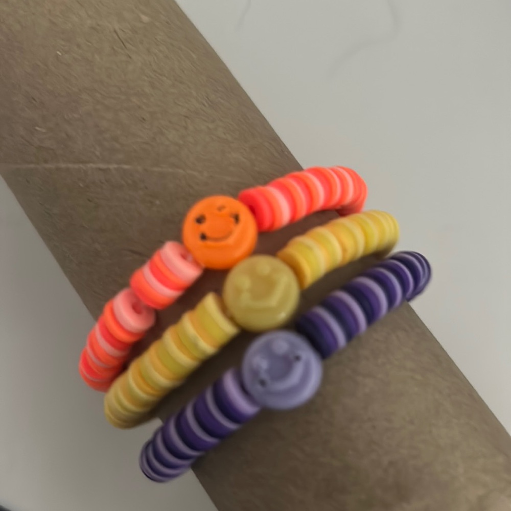 Set of yellow orange and purple clay bead bracelets